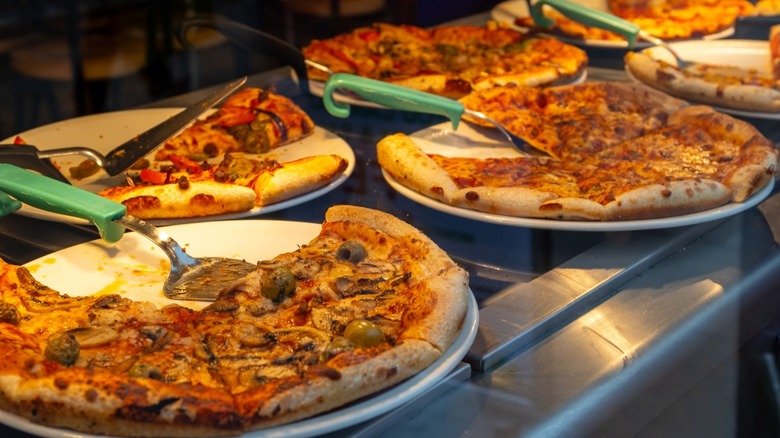 Assorted pizza pies in a display case