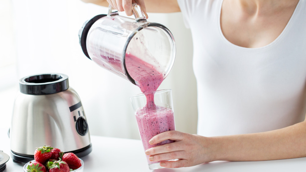 Woman pouring smoothie