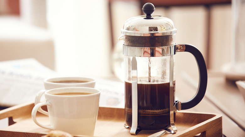 French press with two coffee cups