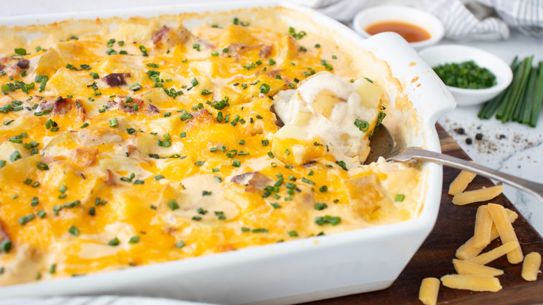 cheese-topped casserole in white pan