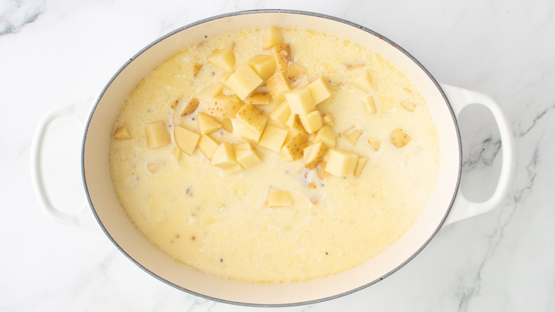 potatoes in white liquid in a white pot
