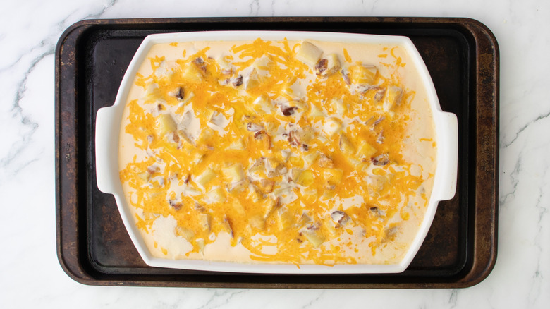 cheese-topped casserole in white pan