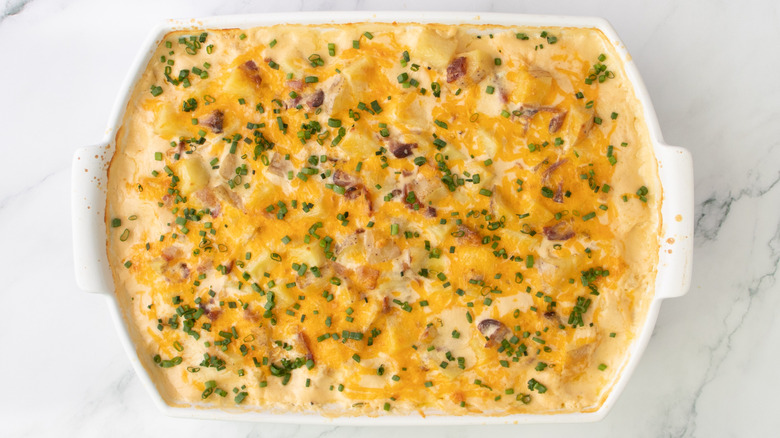cheese-topped casserole in white pan