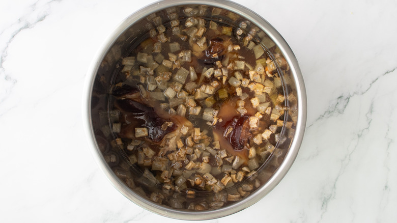 ham hocks and vegetables in a metal pot
