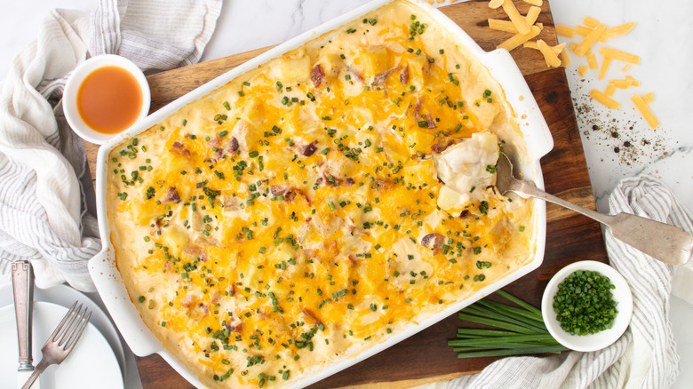 cheese-topped casserole in white pan