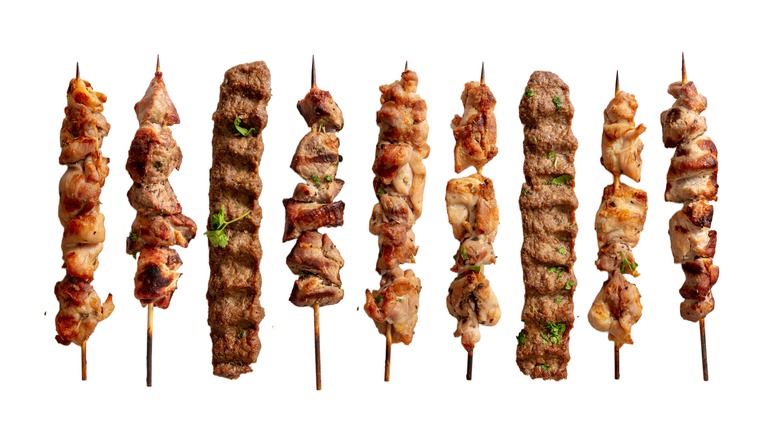 meat kebabs against a white background