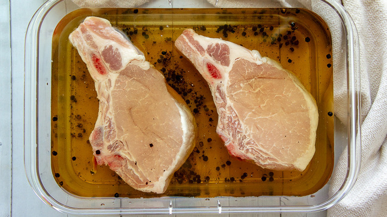 Pork chops soaking in brine.