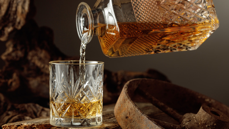 pouring whiskey from decanter