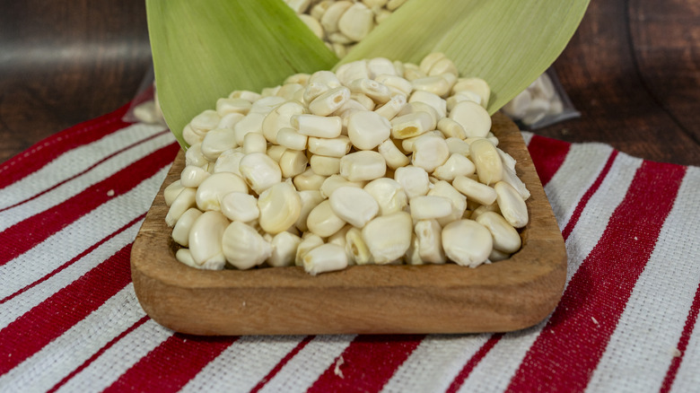 White corn on wooden board with striped cloth