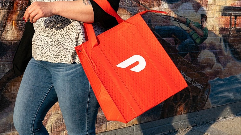 person holding DoorDash bag