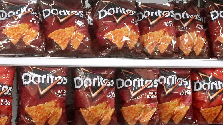 Bags of spicy nacho doritos on grocery store shelf