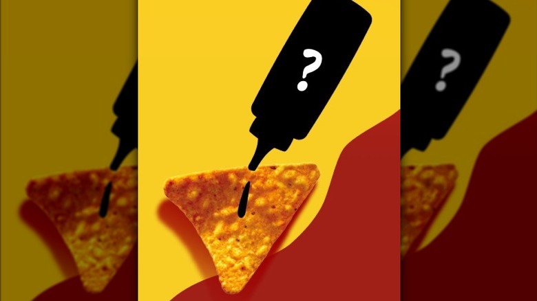 Squeeze bottle over a triangle shaped Doritos on a yellow and red background