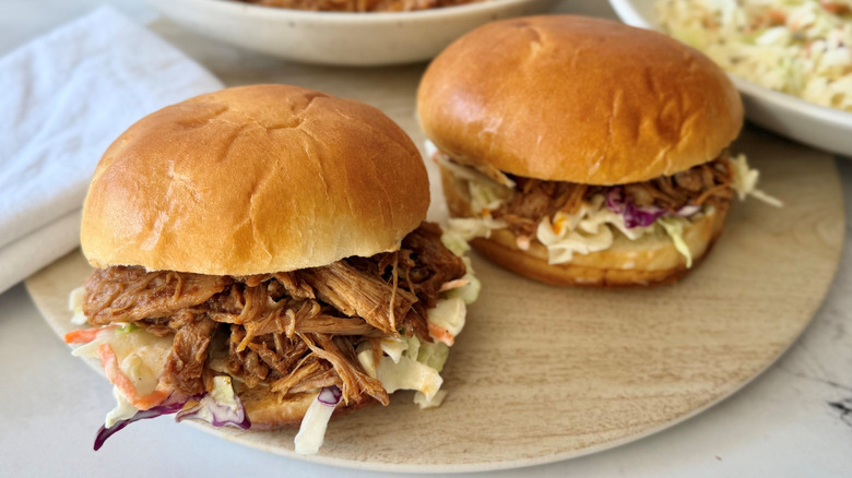 Pulled pork sandwiches on wooden board
