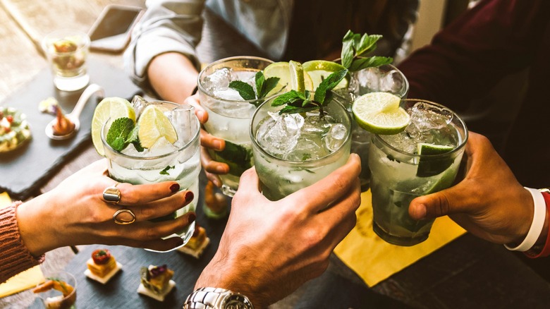 group toasting with cocktails