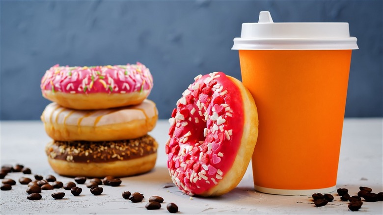 Cup of coffee next to donuts