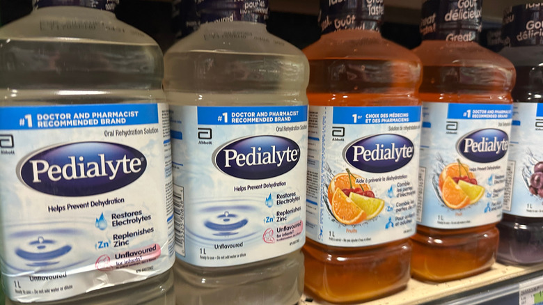Pedialyte bottles on grocery store shelf.
