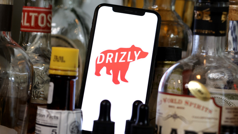 Drizly app surrounded by bottles