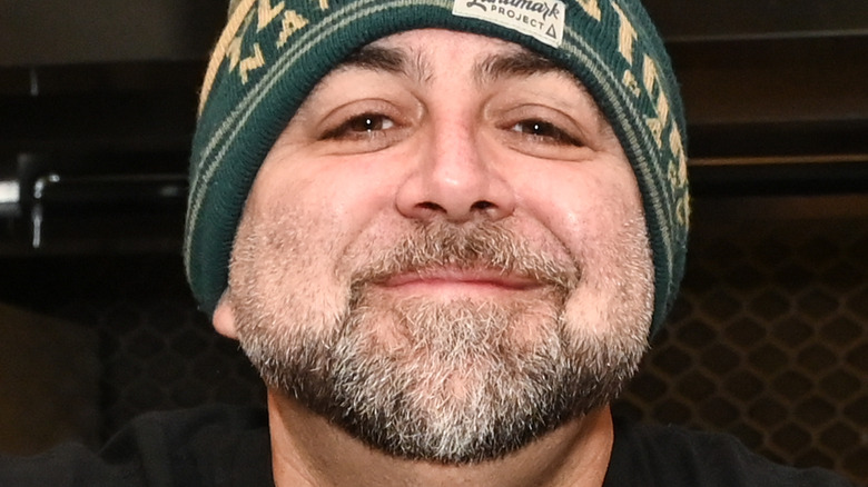 Duff Goldman smiling and wearing green beanie