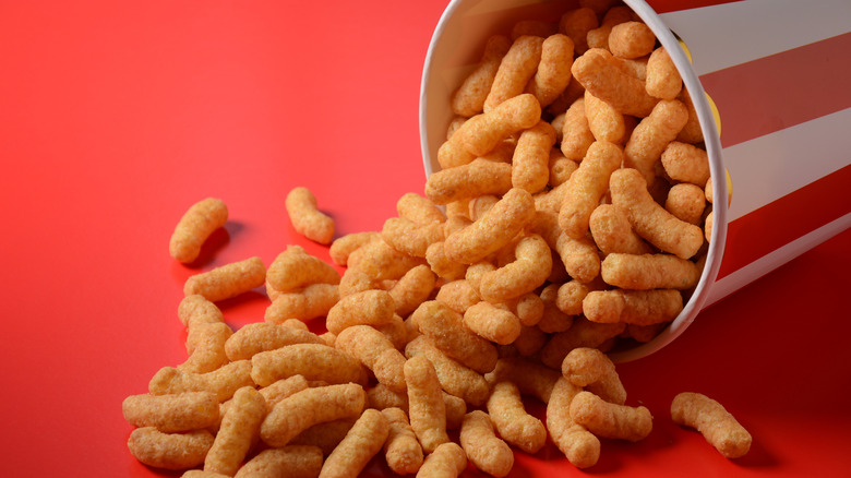 Peanut butter puffs falling out of red and white container