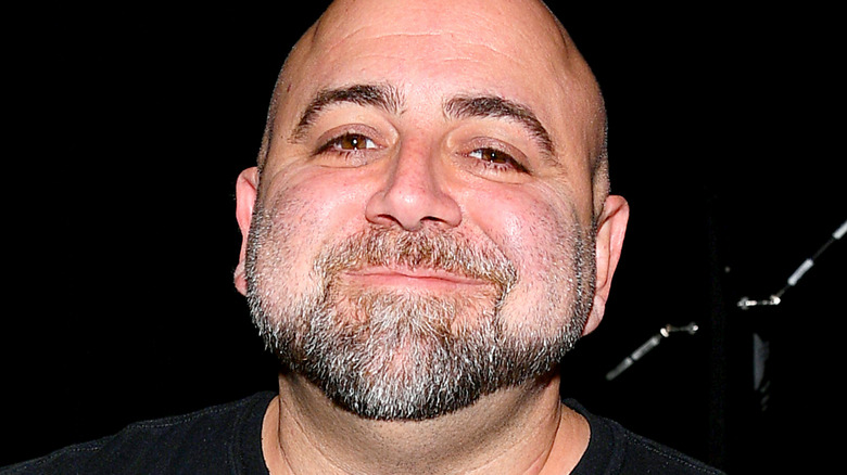 Duff Goldman wearing black T-shirt and smiling