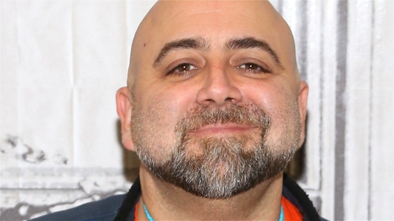 Duff Goldman smiling with grey and brown facial hair