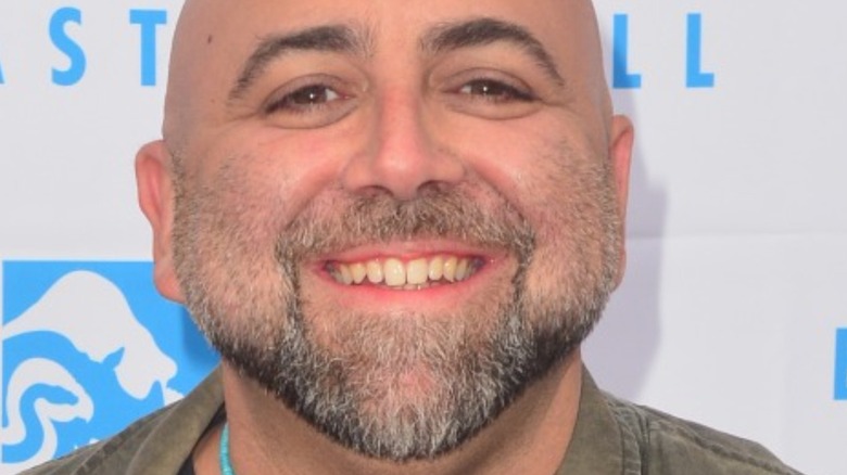 Duff Goldman smiling in blue necklace
