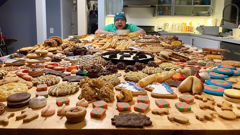 Duff Goldman at the end of a table covered in cookies