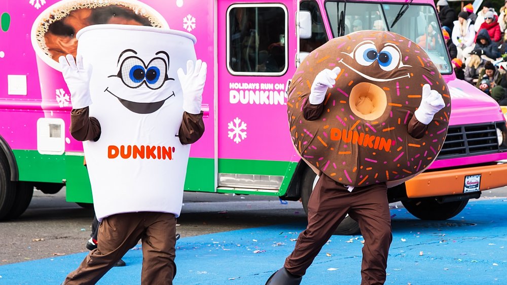 People in Dunkin' doughnut and coffee costumes