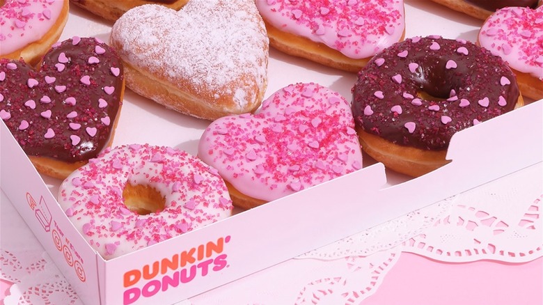 A Dunkin' Donuts box filled with Valentine's Day themed donuts