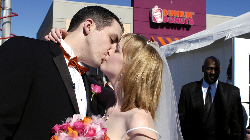 Wedding couple kisses at Dunkin'