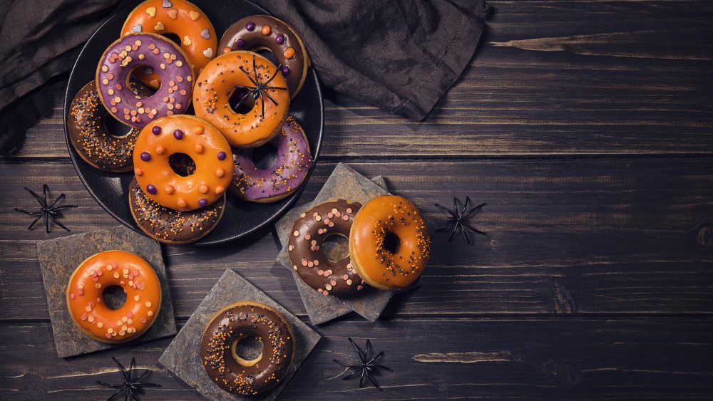 Halloween donuts against a dark wood background