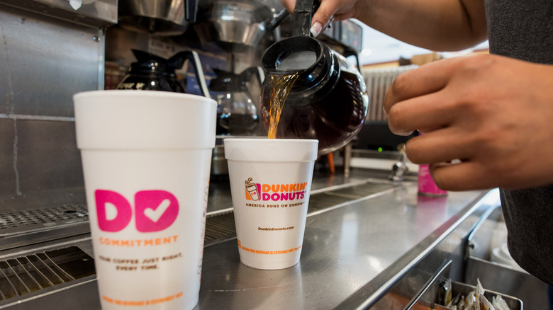 Pouring Dunkin' coffee
