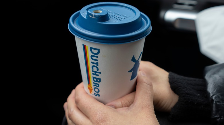 hands holding Dutch Bros coffee