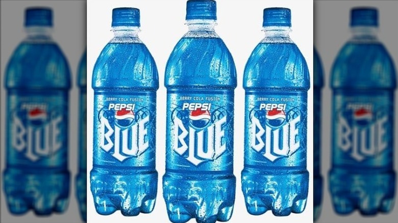 three bottles of Pepsi blue on a white background