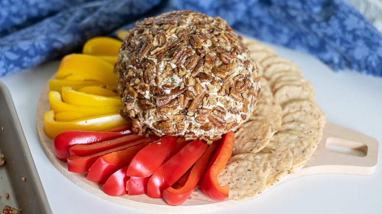 cheese ball with crackers and peppers