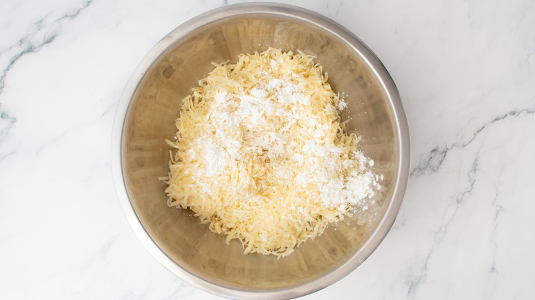 Grated cheese with cornstarch in bowl