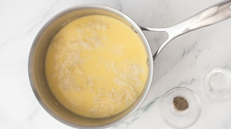 Melting cheese in saucepan