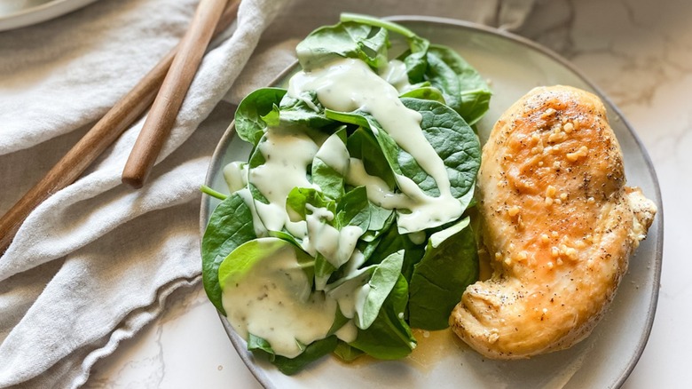 honey garlic baked chicken breast and salad with creamy dressing on plate