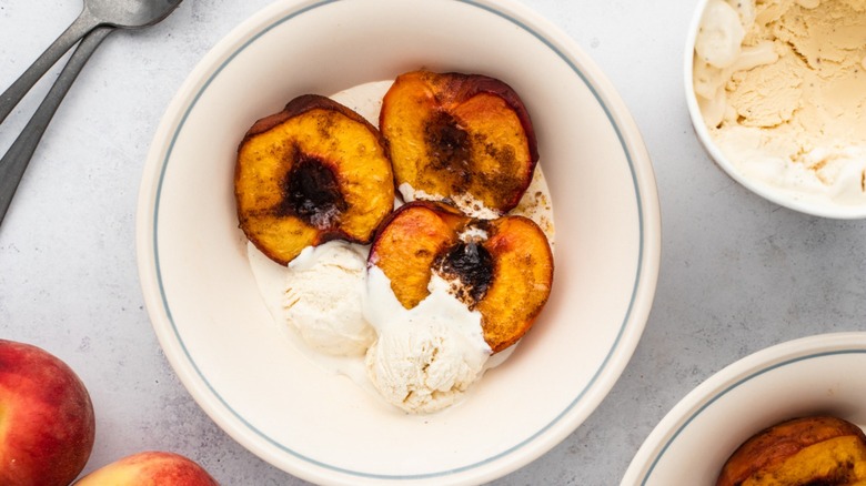 Bowl of baked peaches with ice cream