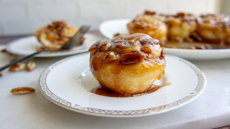 a single caramel pecan sticky bun on a plate