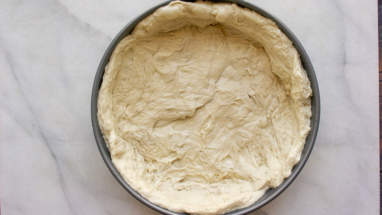 pan with pizza dough