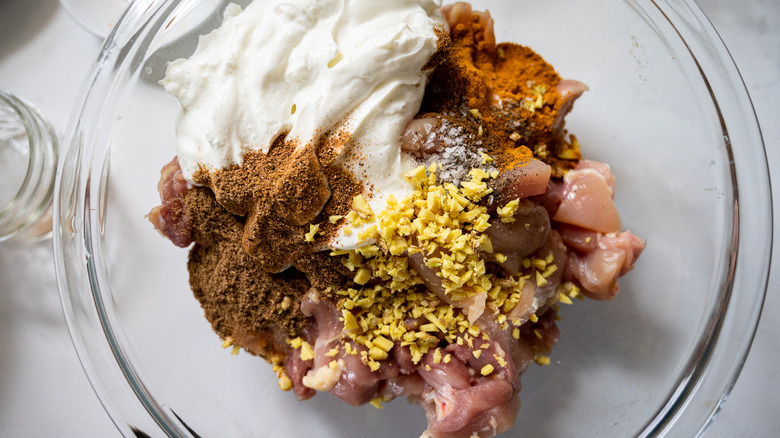 chicken, yogurt, spices in bowl