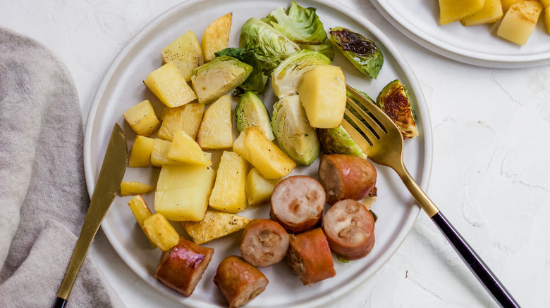 potatoes sausage brussels sprouts on tray