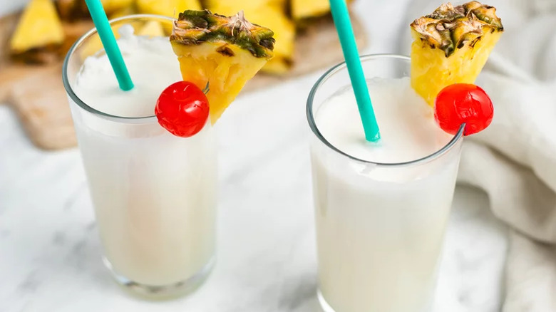 two piña coladas with fruit