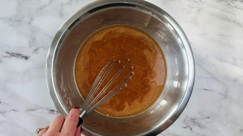 Hand whisking brine in bowl