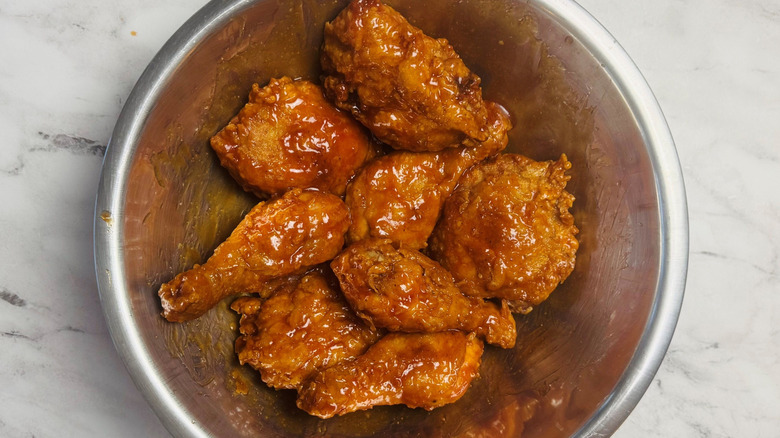 Sauce coated fried chicken in bowl