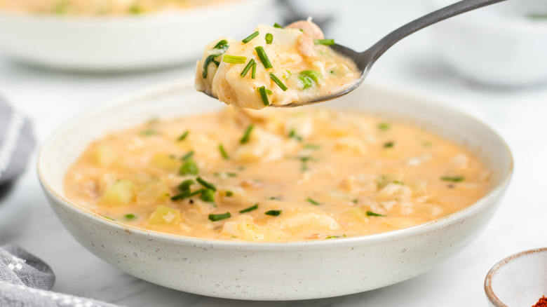 fish chowder on spoon and in bowl