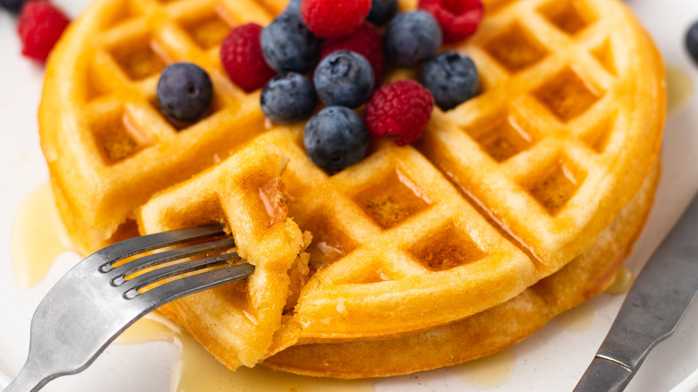 Close up of waffle with piece on fork