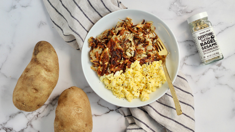 Crispy hash browns served alongside scrambled eggs