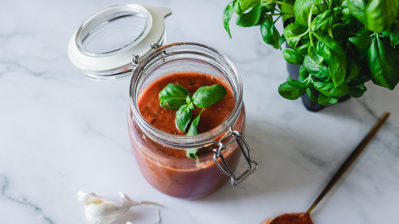 sauce in jar with basil 